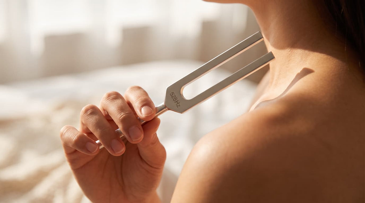 A 528 Hz tuning fork from the Amatro TrueNote Set, held in a hand